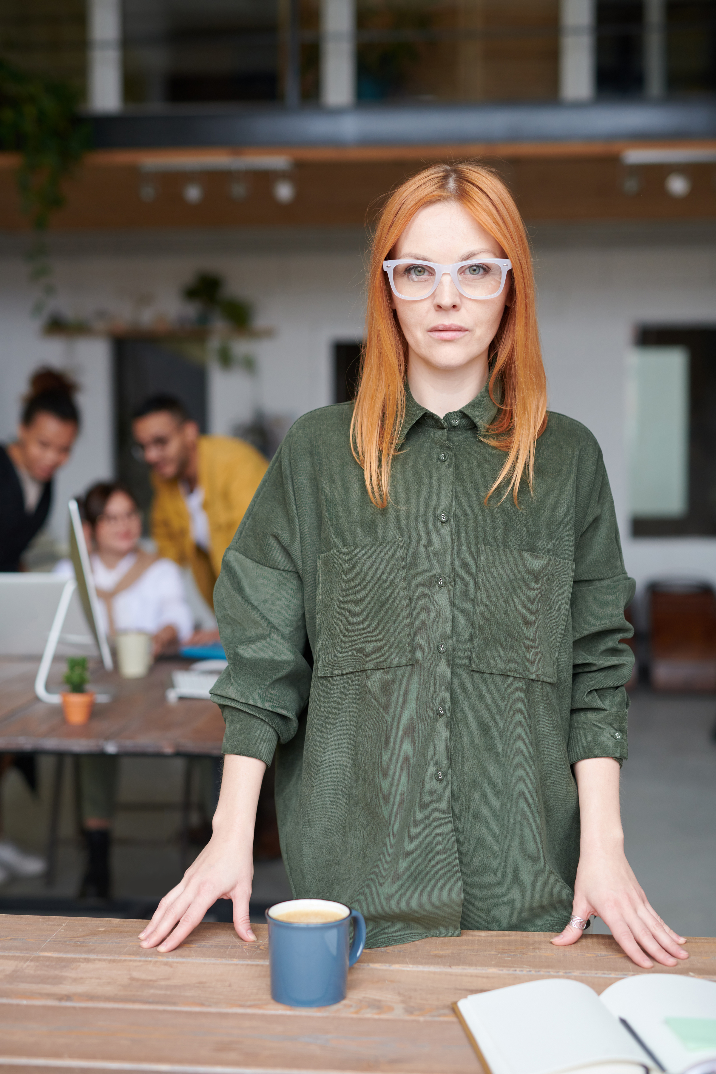 Woman in Green Collared Long-sleeved Top Standing Indoors